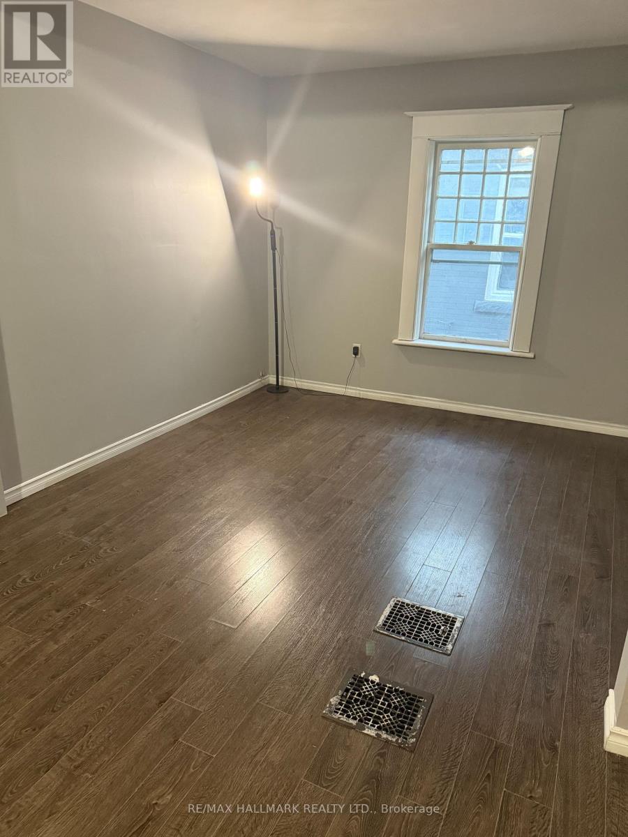 A room with a window and a floor drain.