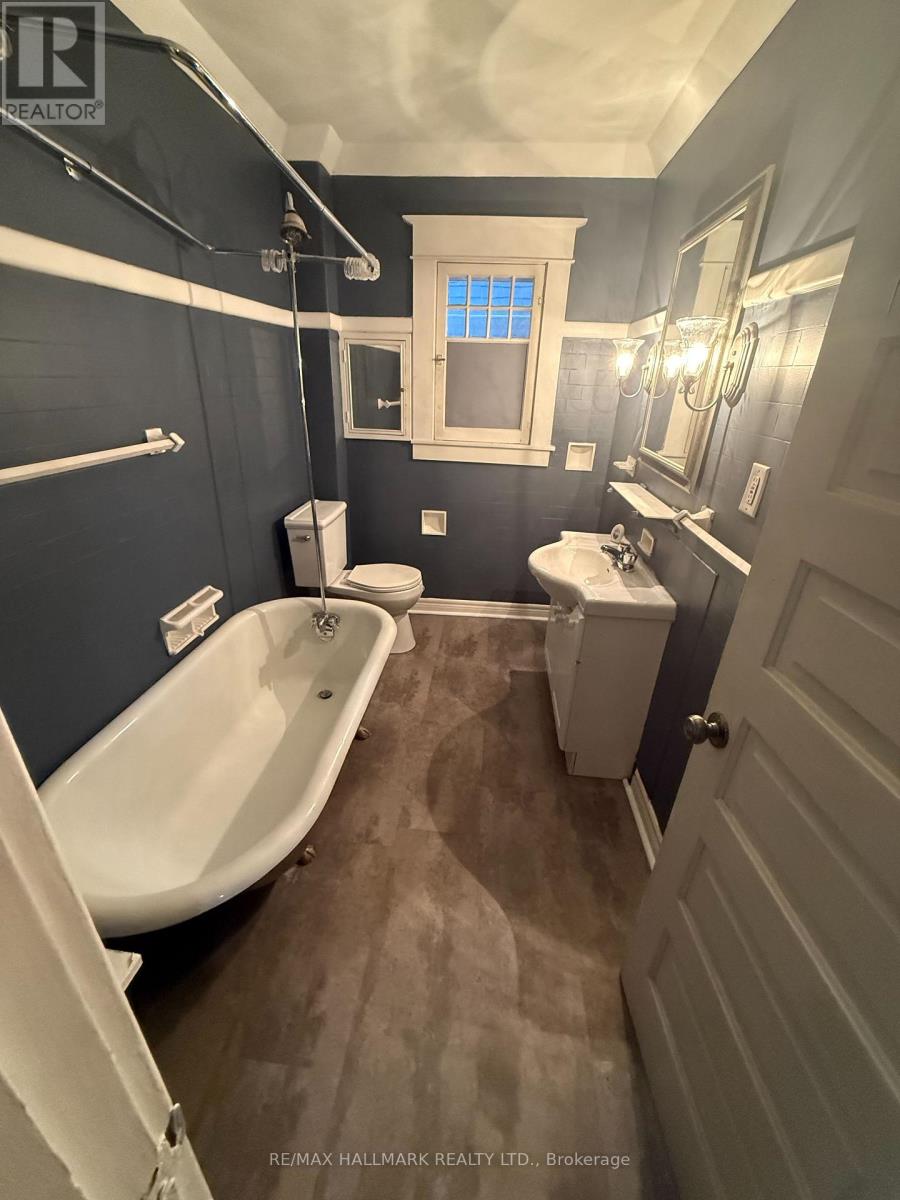 A bathroom with a white tub and a toilet.