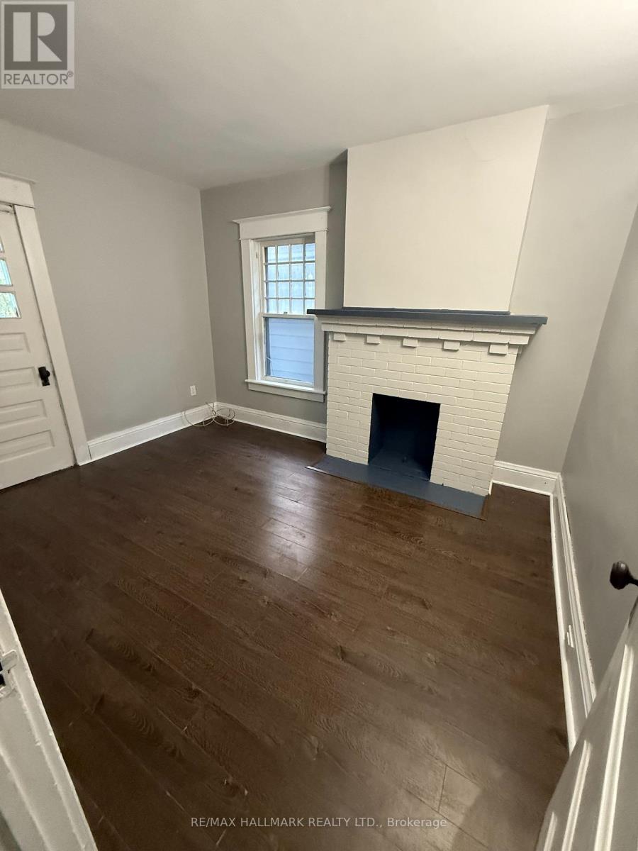 A room with a fireplace and a window.