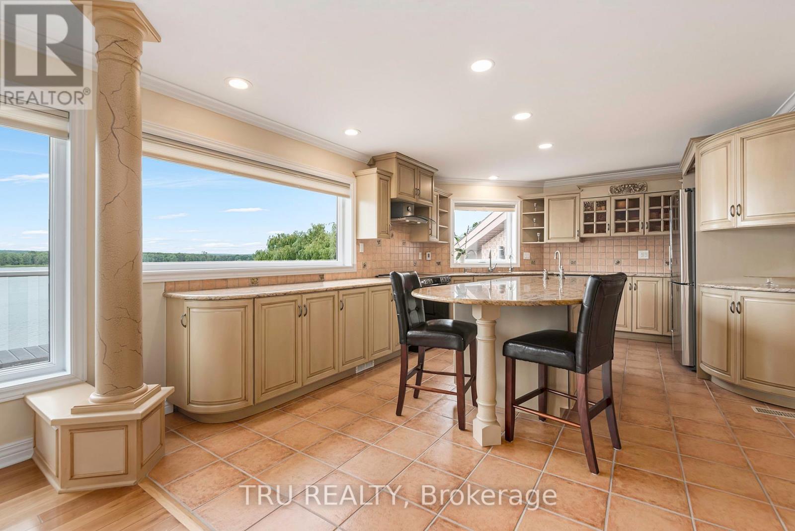 A kitchen with a table and chairs in the middle of the room.