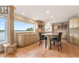 A kitchen with a table and chairs in the middle of the room.