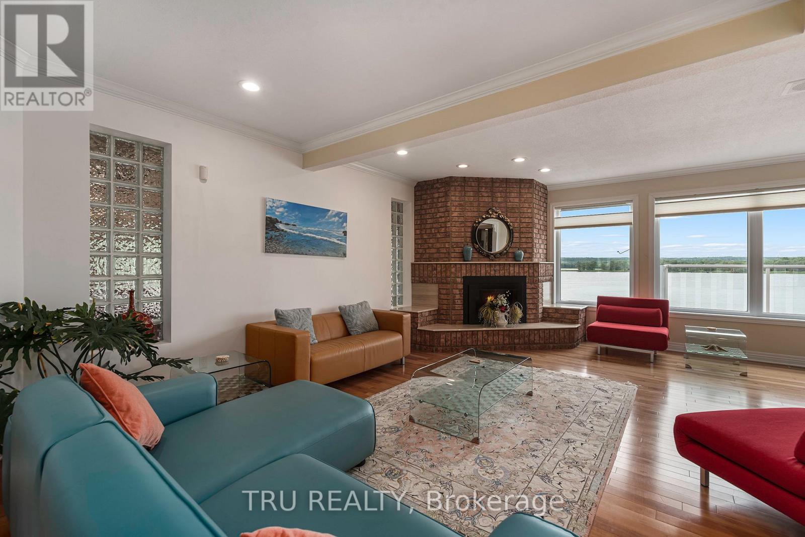 A living room with a fireplace and a painting on the wall.