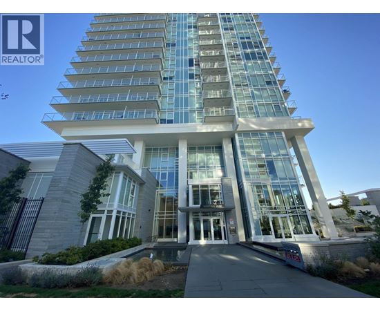 A tall building with a glass facade and a sign that says REALTOR.