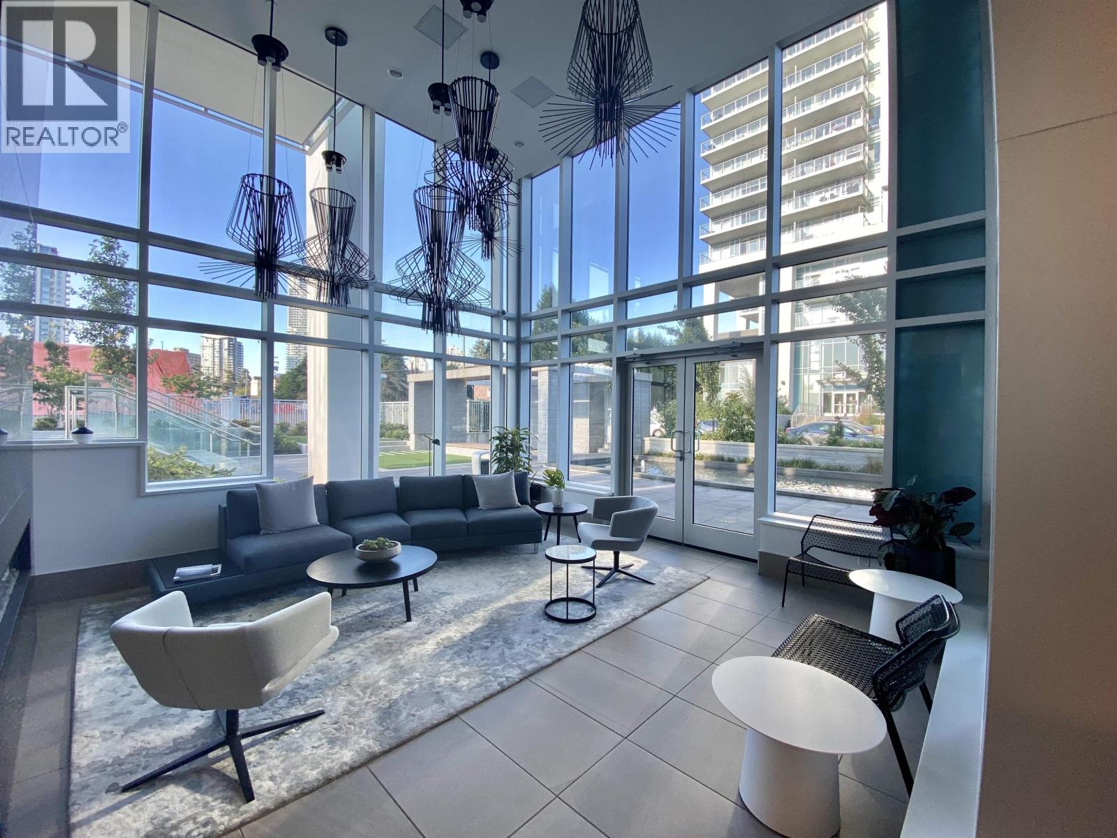 A modern living room with a large window and furniture.