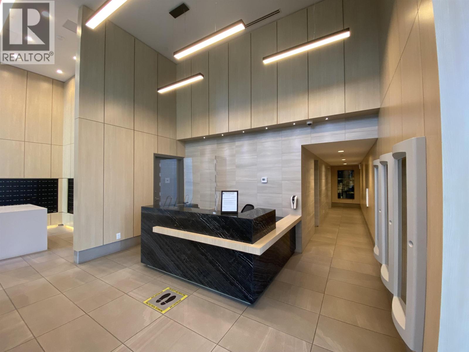 A reception area with a black counter and a white reception desk.