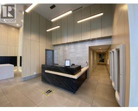 A reception area with a black counter and a white reception desk.