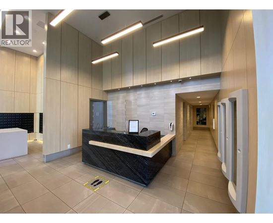 A reception area with a black counter and a white reception desk.