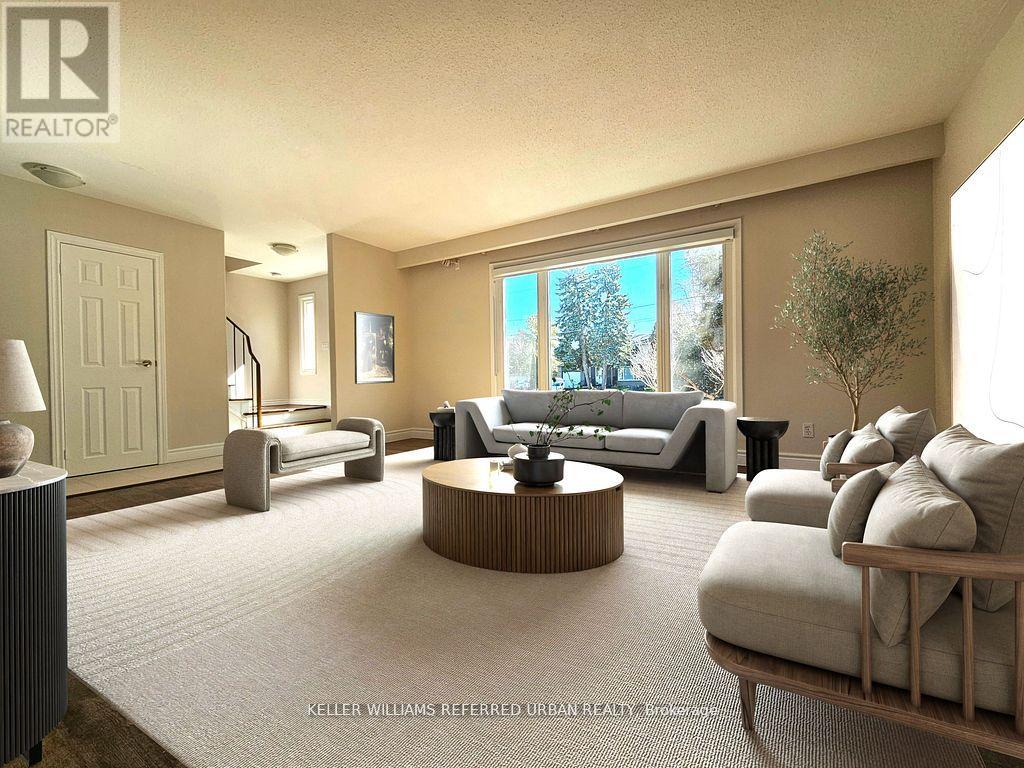 A well-lit living room with a large window and furniture.