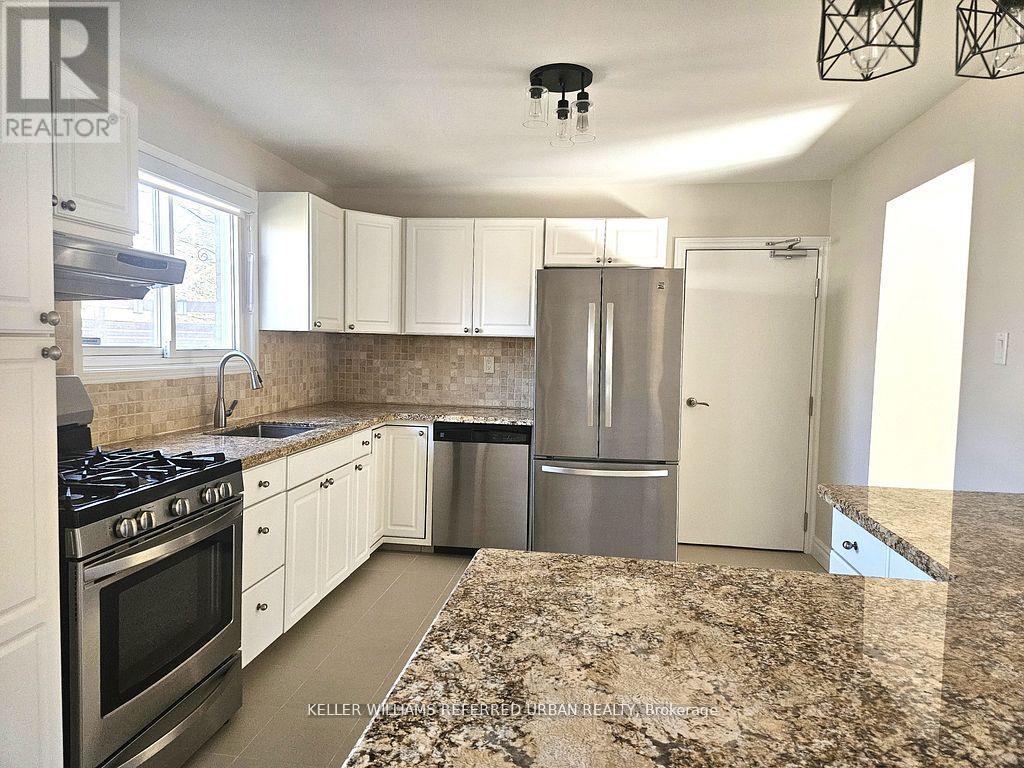 A kitchen with granite countertops and stainless steel appliances.