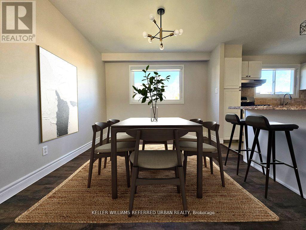 A dining room with a table and chairs.