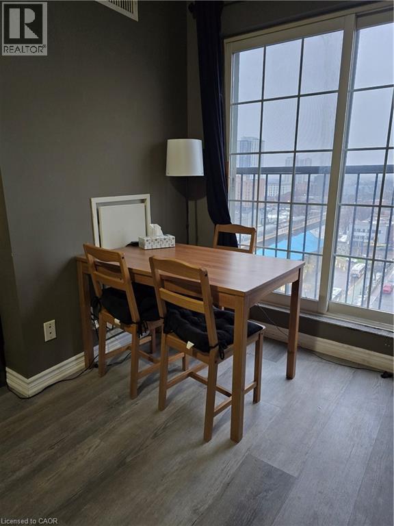 A dining room with a wooden table and chairs.