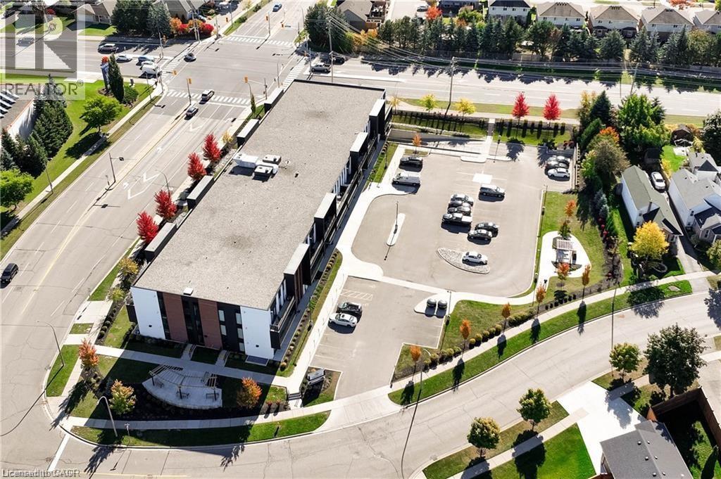 A realtor's image of a building with a parking lot in front.