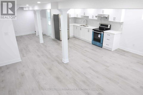 A spacious kitchen with white cabinets and a blue oven.