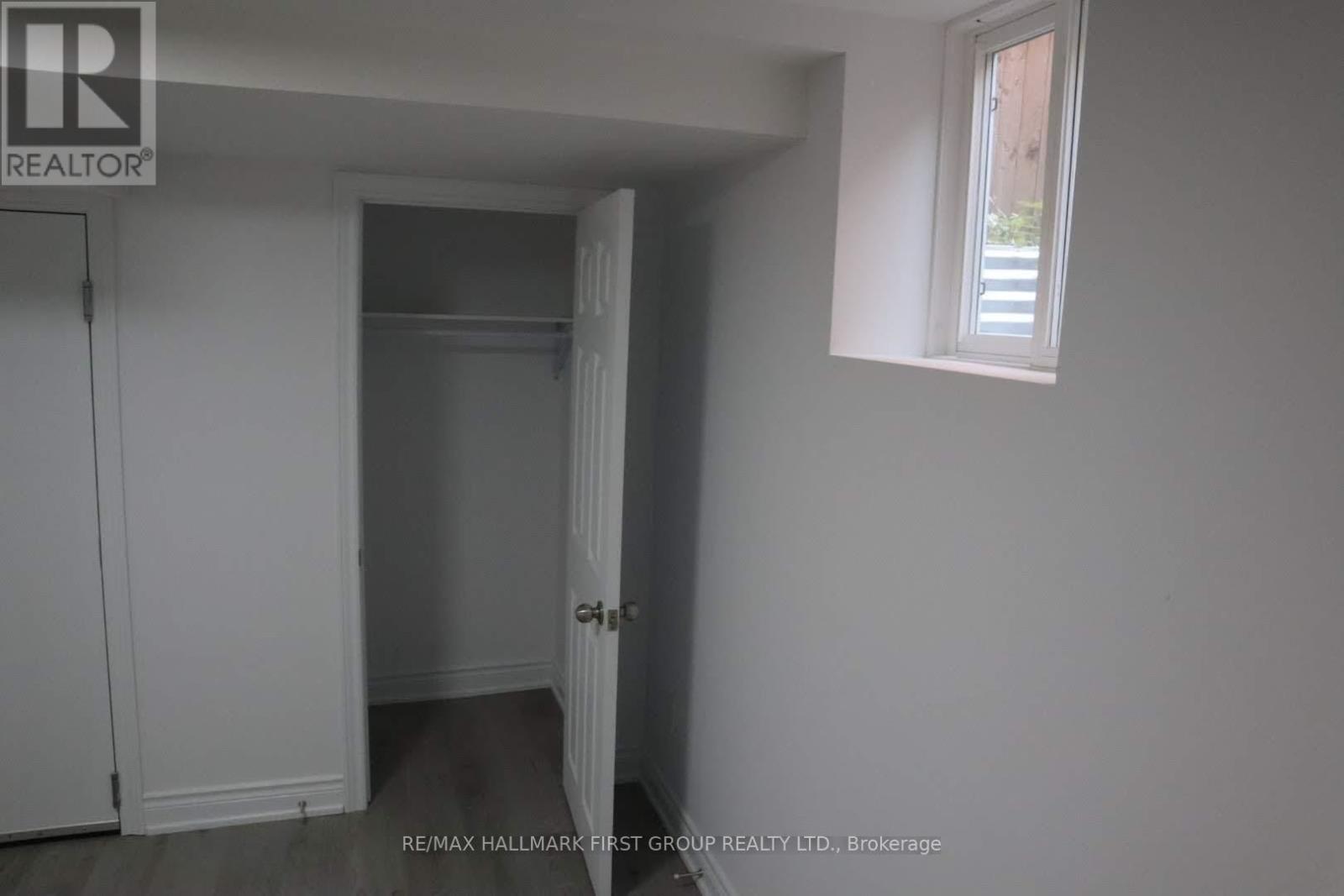 A white room with a door and a window.