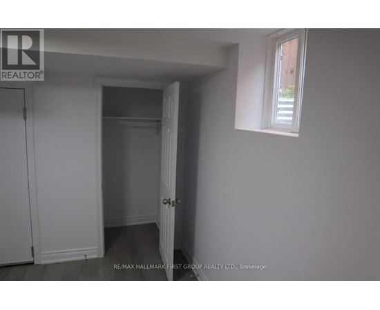 A white room with a door and a window.