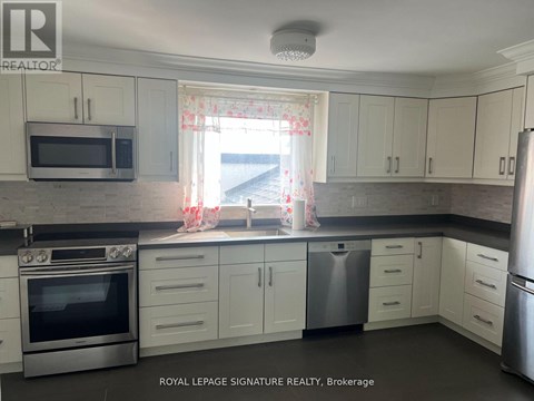 A kitchen with white cabinets and stainless steel appliances.