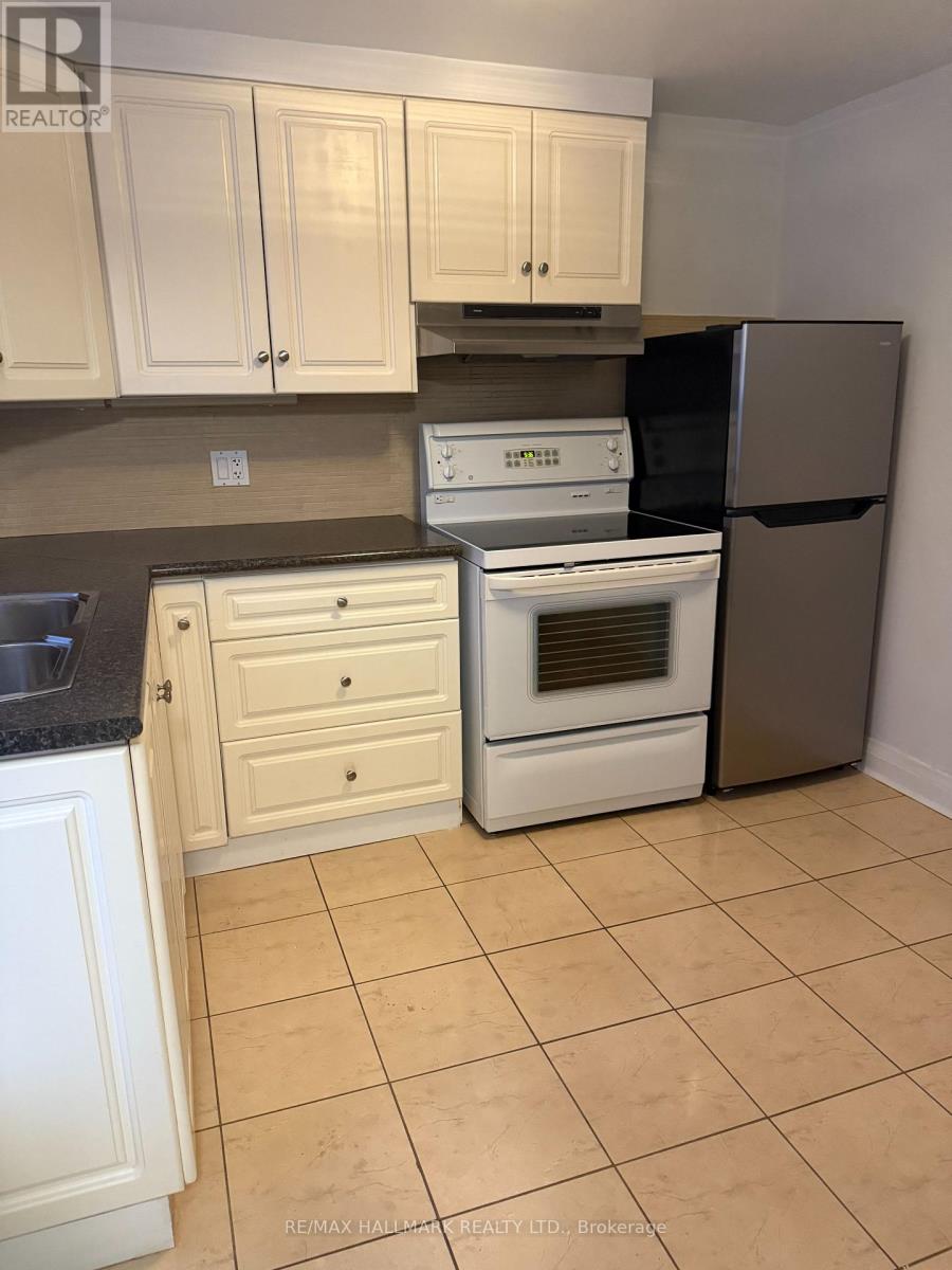 A kitchen with white appliances and cabinets.