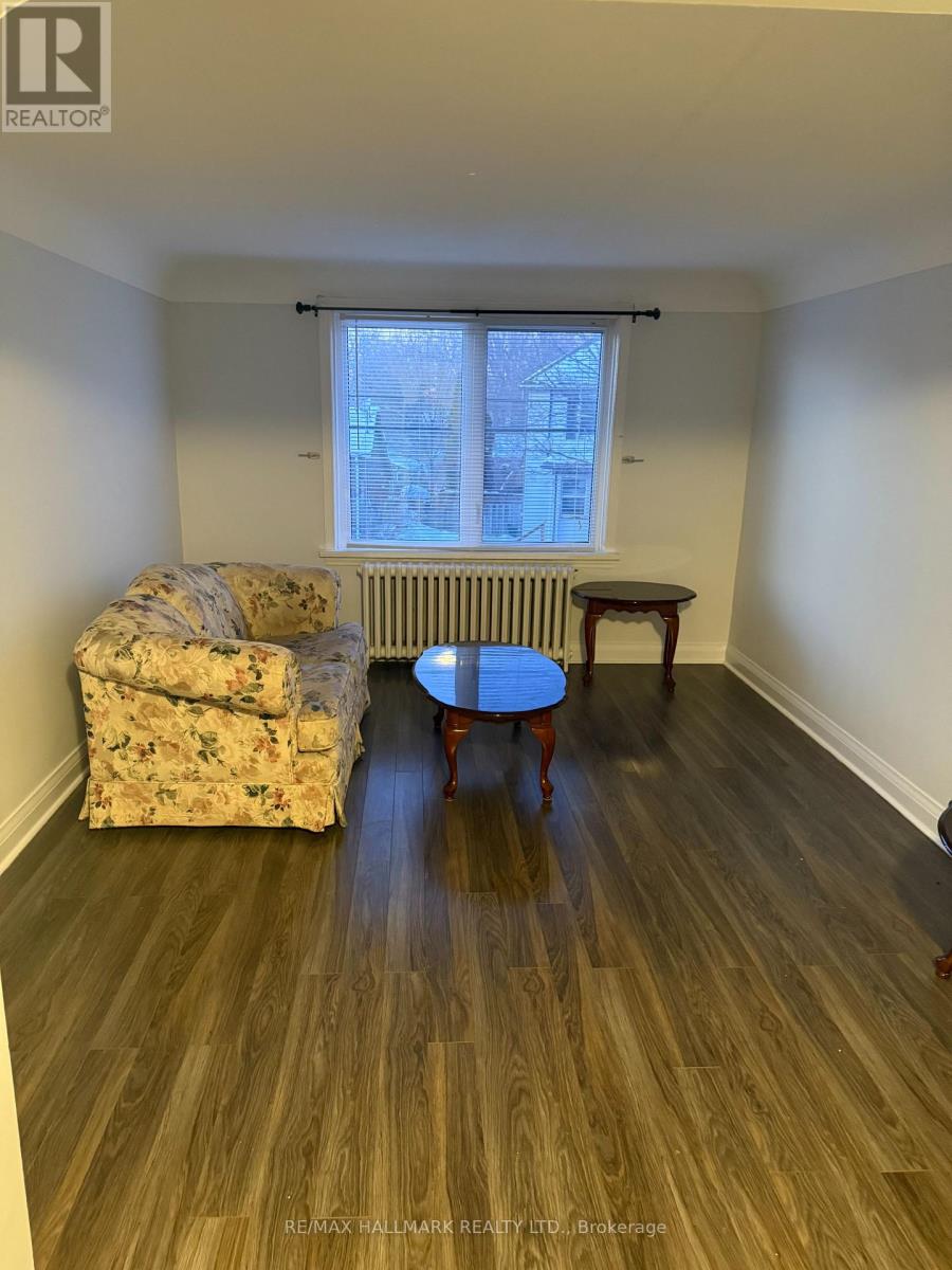 A room with a couch, chair, and table in it.