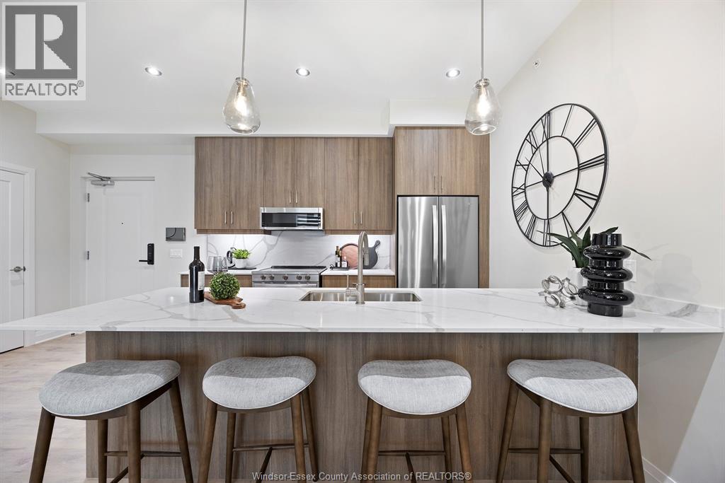 A kitchen with a bar area and a clock on the wall.