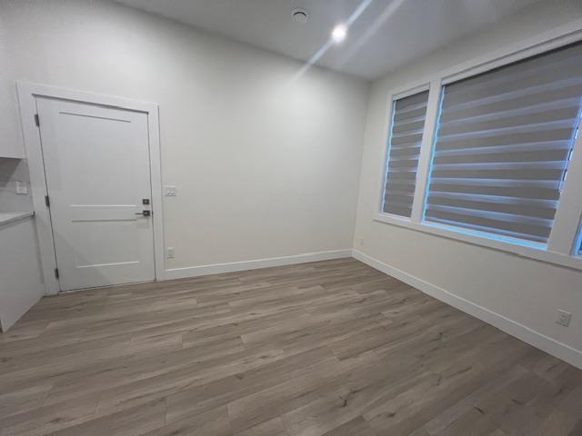A room with a white door and a window with blinds.
