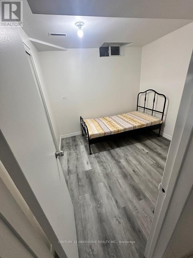 A bedroom with a bed and a light on the ceiling.