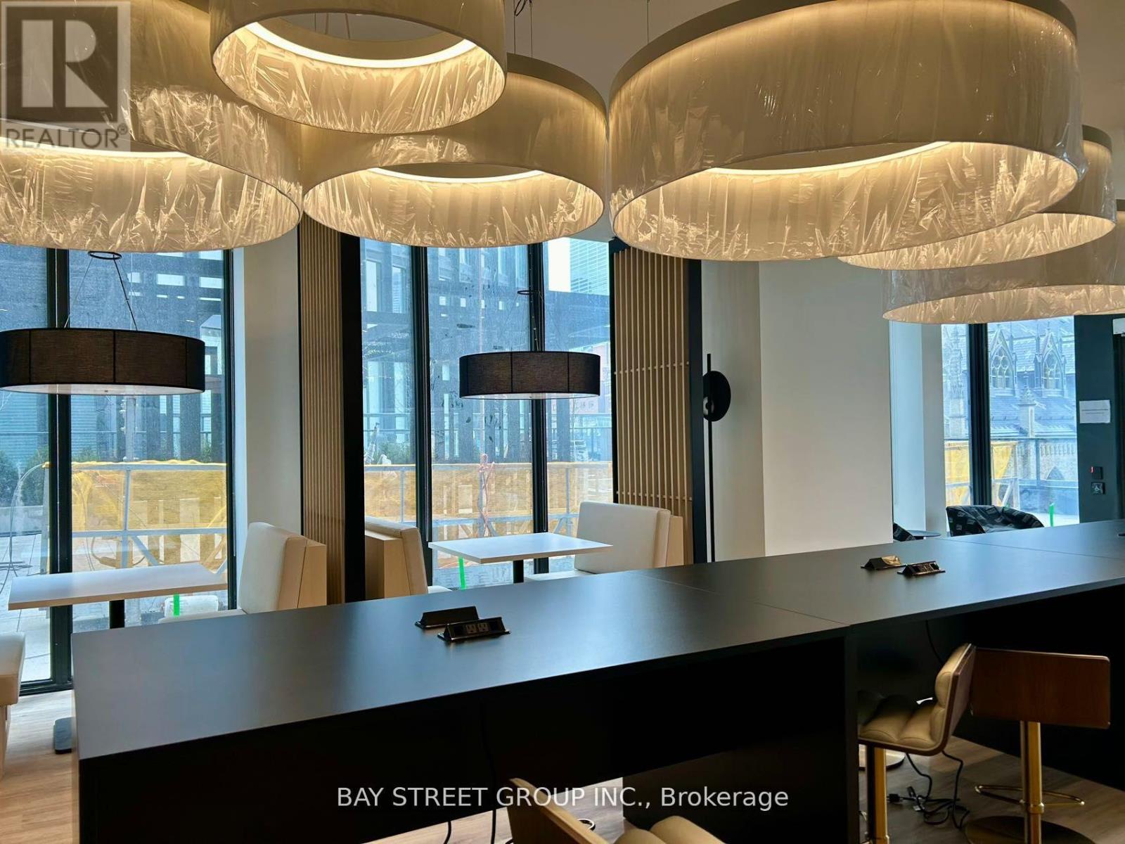 A modern office space with a reception desk and chairs.