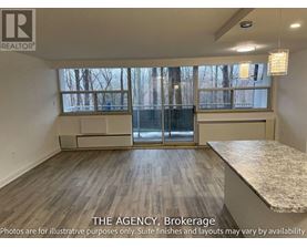 A room with a large window and a marble countertop is for sale.
