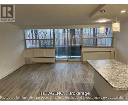 A room with a large window and a marble countertop is for sale.