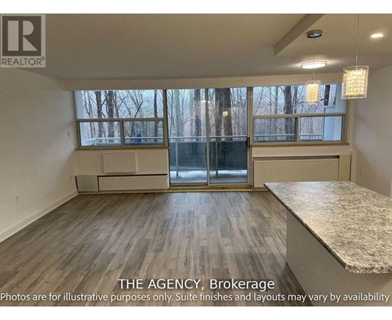 A room with a large window and a marble countertop is for sale.