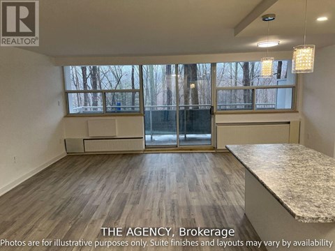 A room with a large window and a marble countertop is for sale.