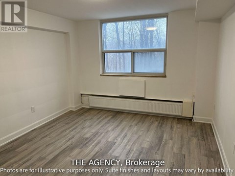 A room with a window and a radiator on the floor.
