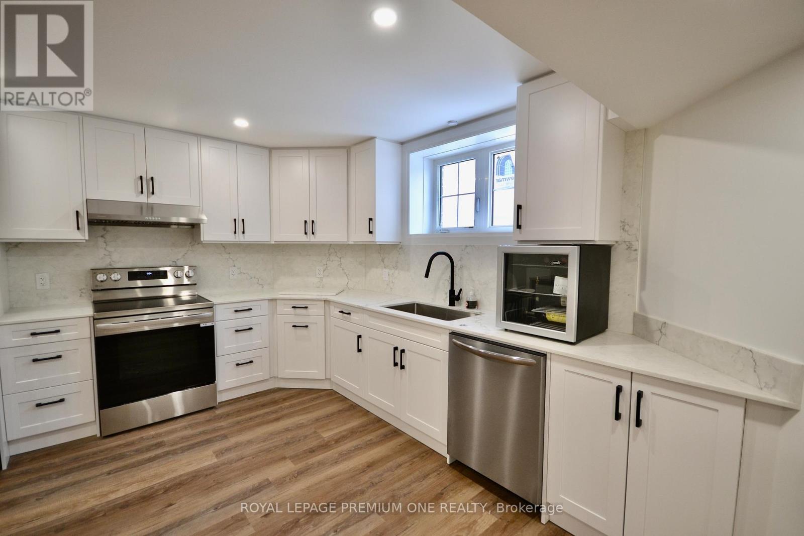 A kitchen with white cabinets and stainless steel appliances.