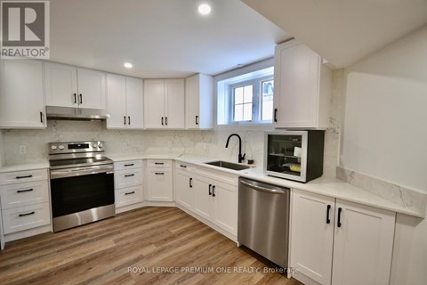 A kitchen with white cabinets and stainless steel appliances.