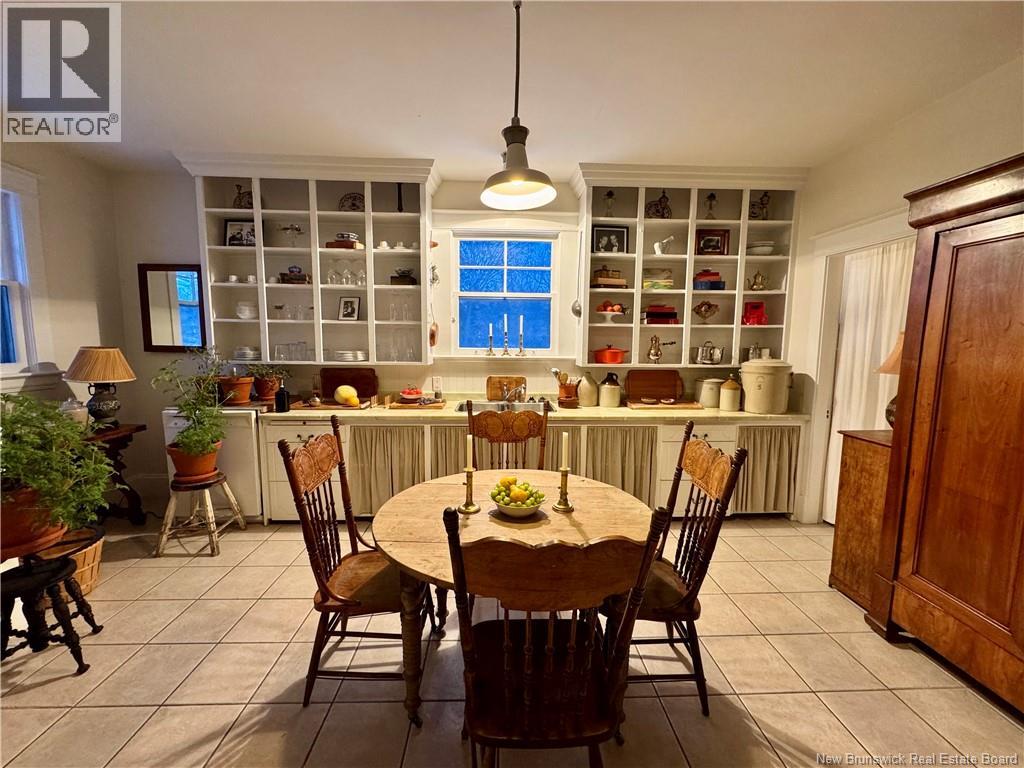 A dining room with a table set for four.