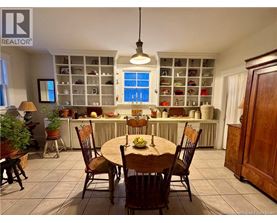 A dining room with a table set for four.