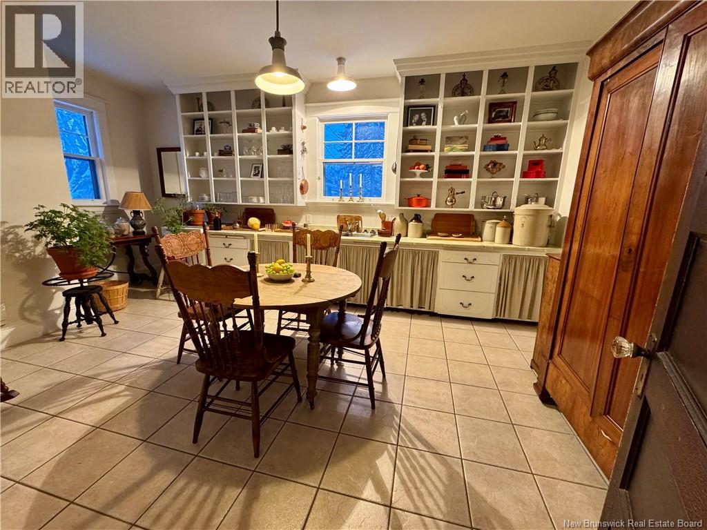 A kitchen with a table and chairs in the middle of the room.