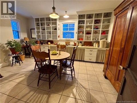 A kitchen with a table and chairs in the middle of the room.