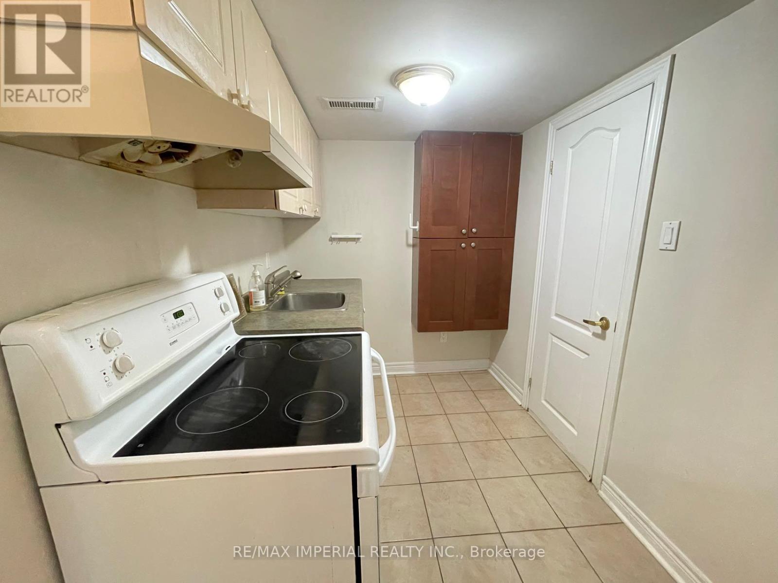 A small kitchen with a white stove and a white oven.