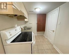 A small kitchen with a white stove and a white oven.