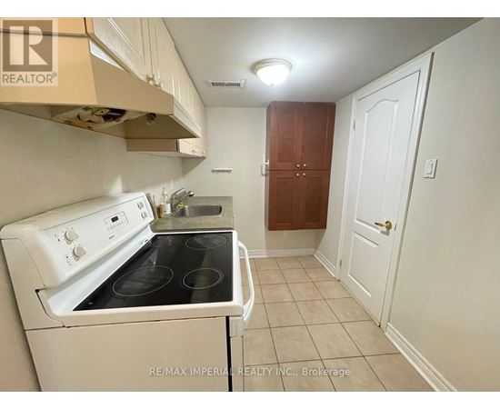 A small kitchen with a white stove and a white oven.