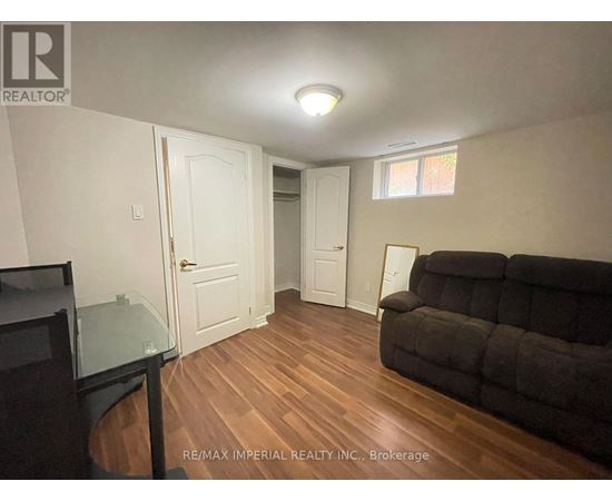 A living room with a couch and a television.