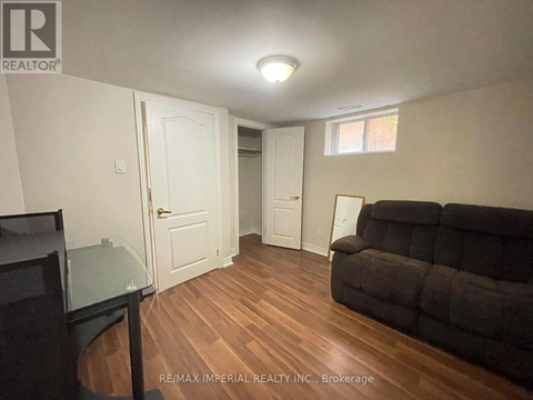 A living room with a couch and a television.