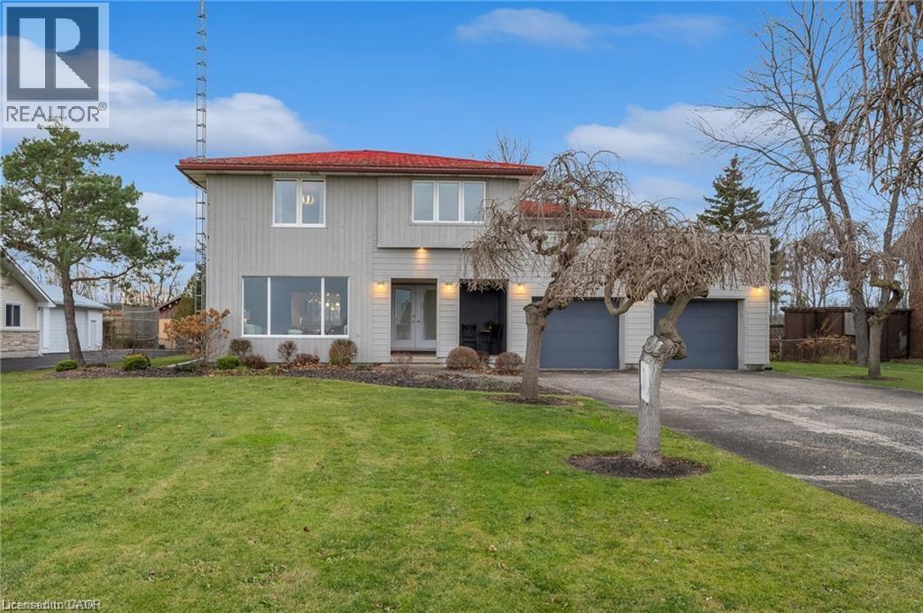 A house with a red roof and a sign that says REALTOR.