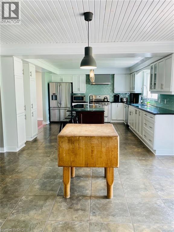 A kitchen with a wooden box on the floor.