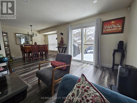 A living room with a dining table and chairs.