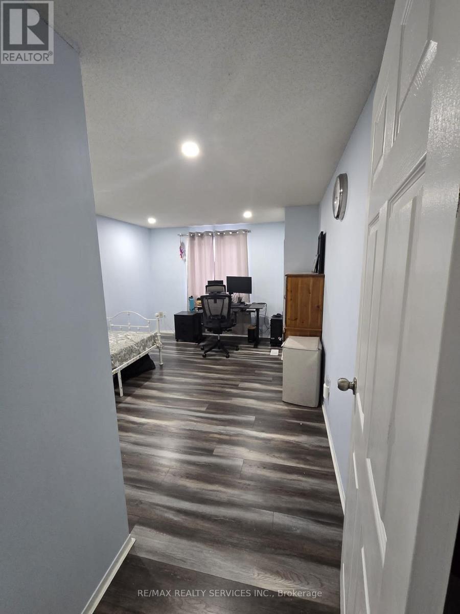A room with a bed, desk, and chair.