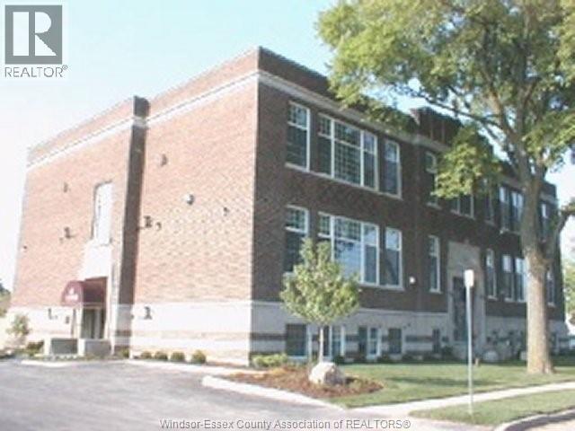 A brick building with a tree in front of it.