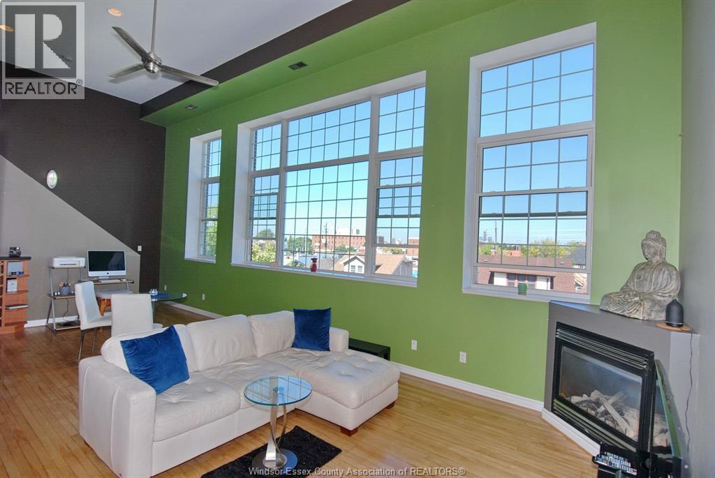 A living room with a white couch and a television.