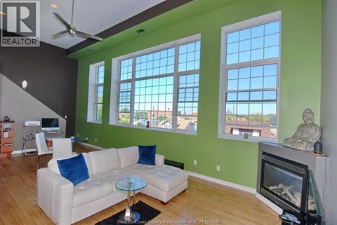 A living room with a white couch and a television.
