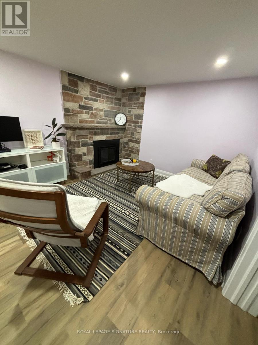 A living room with a fireplace and a striped couch.